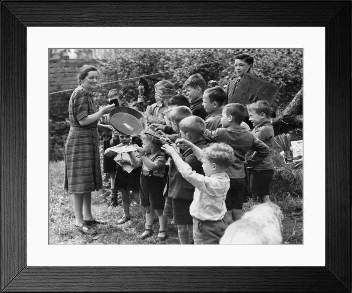 Framed Print : Evacuated children in St Ives present Miss Hunt with gifts on her birthday during