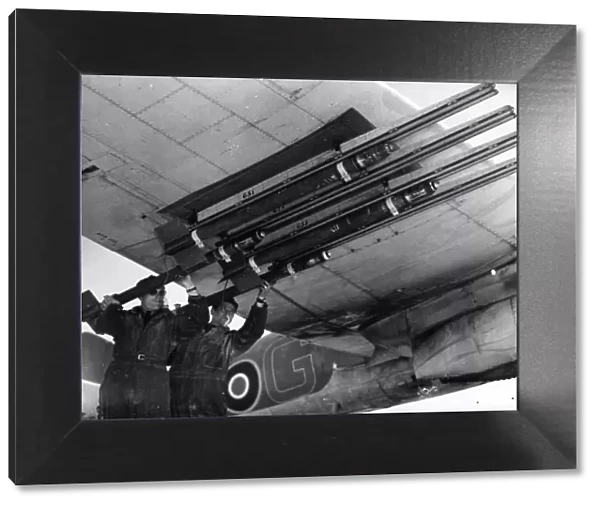 R. A. F ground crew equipping Beaufighters with rocket projectiles