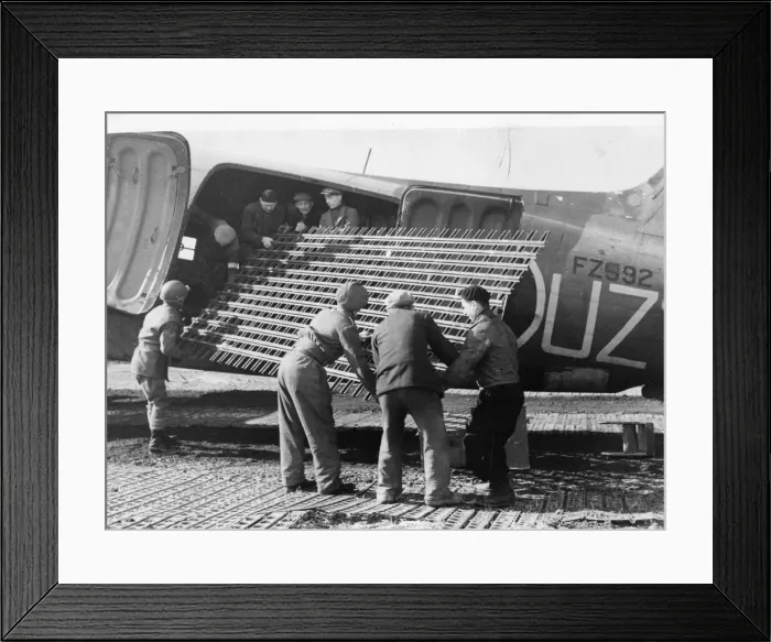 Framed Print : The RAF unloading metal runway strips from a Dakota transport plane in Belgium Framed Print : The RAF unloading metal runway strips from a Dakota transport plane in Belgium
