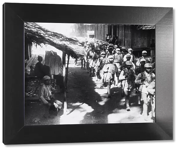 Chinese troops enter a Burmese village during Second World War. Circa March 1945