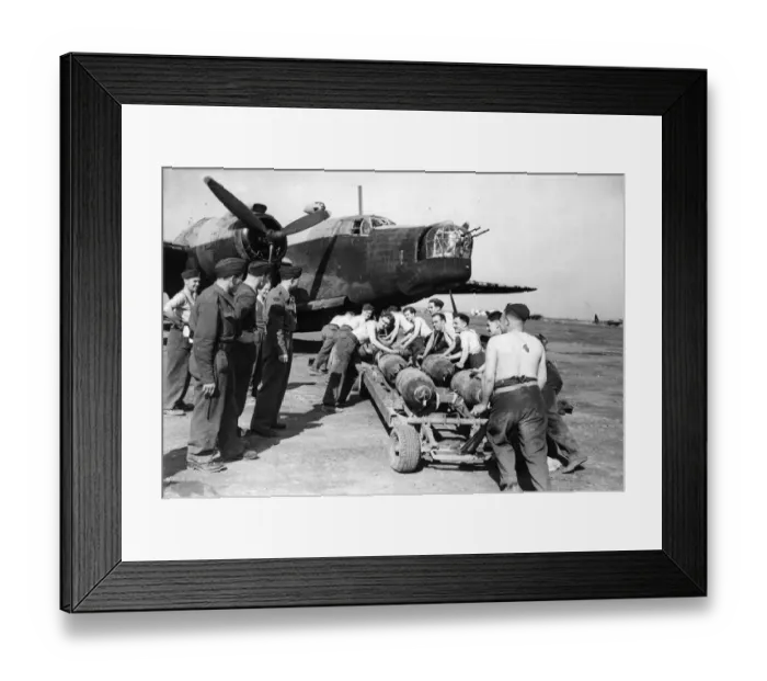 Framed Print : Stripped to the waist, RAF ground crews in North Africa bomb up