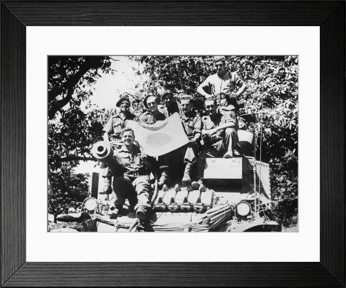 Framed Print : The crew of a Lee tank pose with a captured Japanese flag during the advance south of Framed Print : The crew of a Lee tank pose with a captured Japanese flag during the advance south of