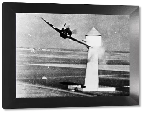 An 8th U. S. A. A. F. P-47 attacks a flak tower at a German aerodrome in occupied France
