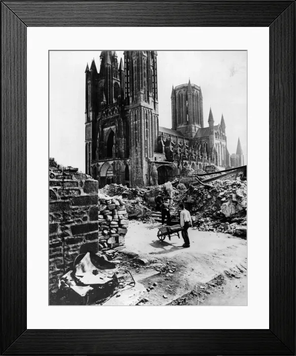 Framed Print : French civilians clearing rubble of destroyed houses beside the church in Periers, France
