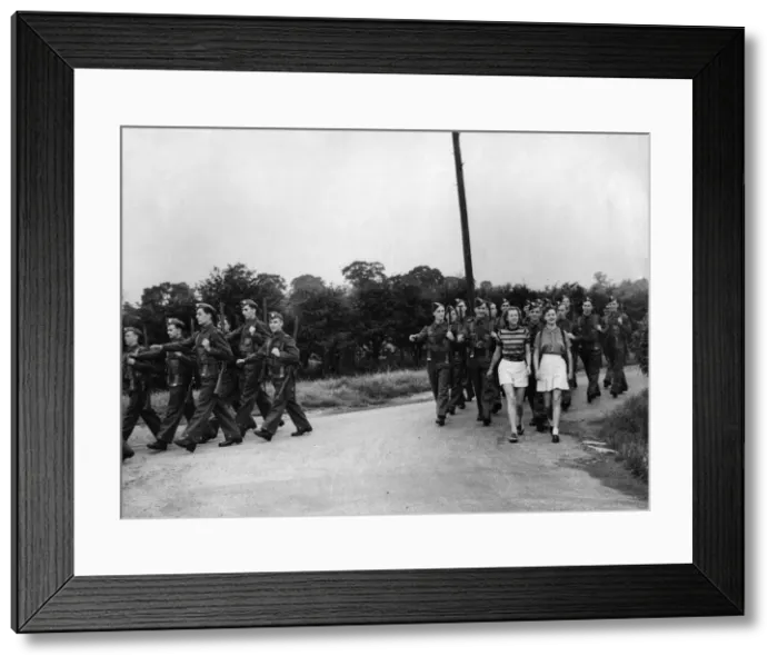 Framed Print : British Soldiers marching in the countryside, distracted by two young women they Framed Print : British Soldiers marching in the countryside, distracted by two young women they