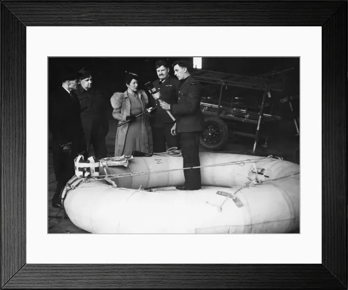 Framed Print : Mr S. R. Johnson (left) and Miss V. S. Bowers inspecting the rubber dinghy which their firm Framed Print : Mr S. R. Johnson (left) and Miss V. S. Bowers inspecting the rubber dinghy which their firm