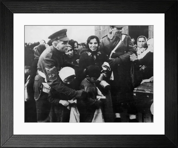 Framed Print : A Military Policeman shepherds children through a crowd to receive rations, Athens Framed Print : A Military Policeman shepherds children through a crowd to receive rations, Athens