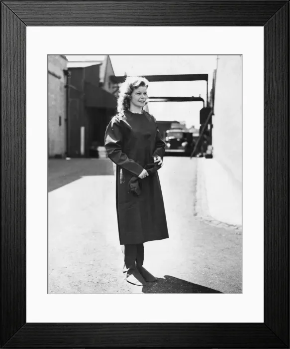 Framed Print : War munition workers. A lady in her thick rubber protective overall Framed Print : War munition workers. A lady in her thick rubber protective overall