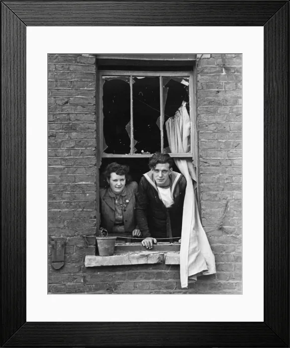 Framed Print : The bride and Royal Navy groom look out of their window, onto where a bomb recently fell Framed Print : The bride and Royal Navy groom look out of their window, onto where a bomb recently fell