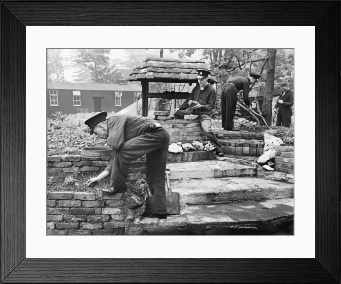 Framed Print : Work begin done on a rockery, under the instruction of Fireman C A Bull
