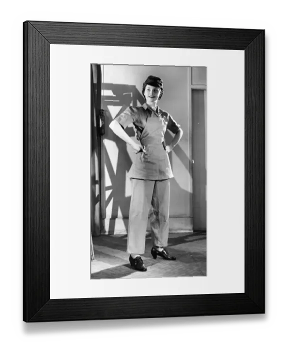 Framed Print : A lady models some of the latest army clothing. An Overall