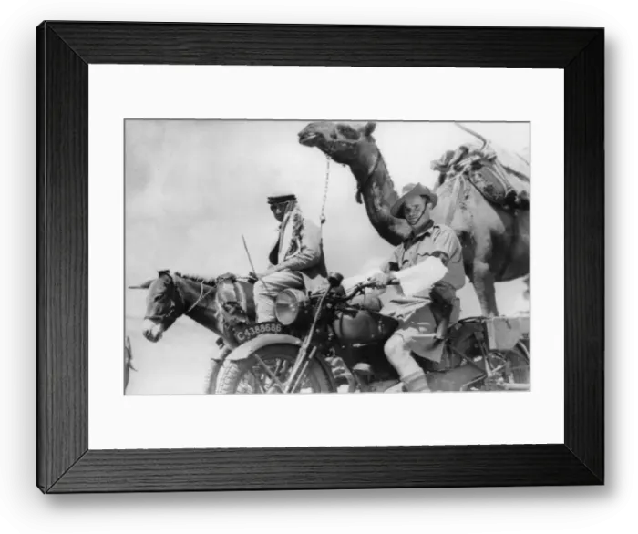 Framed Print : A soldier of the Australian Imperial Force on his motorcycle passing one of the caravans Framed Print : A soldier of the Australian Imperial Force on his motorcycle passing one of the caravans