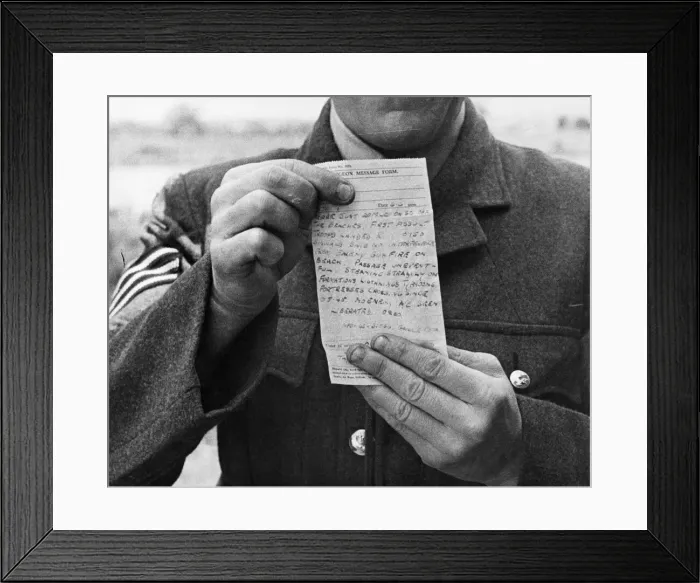 Framed Print : A telegram message from the front, shown to camera by an officer Framed Print : A telegram message from the front, shown to camera by an officer