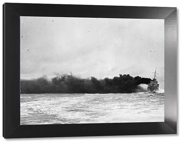 The Royal Navy Hunt class destroyer HMS Meynell conceals herself behind a smoke screen