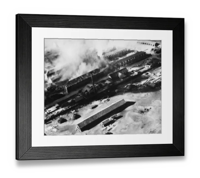 Framed Print : Japanese barracks on Tokushima airfield in Japan being bombed by the British Navy