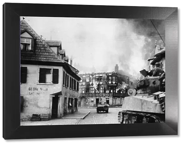 Units of General Pattons 11th Armoured Division drive through Kronach, Germany