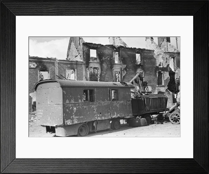 Framed Print : Ruined buildings and wrecked German transport in the streets of Montebourg as a result of