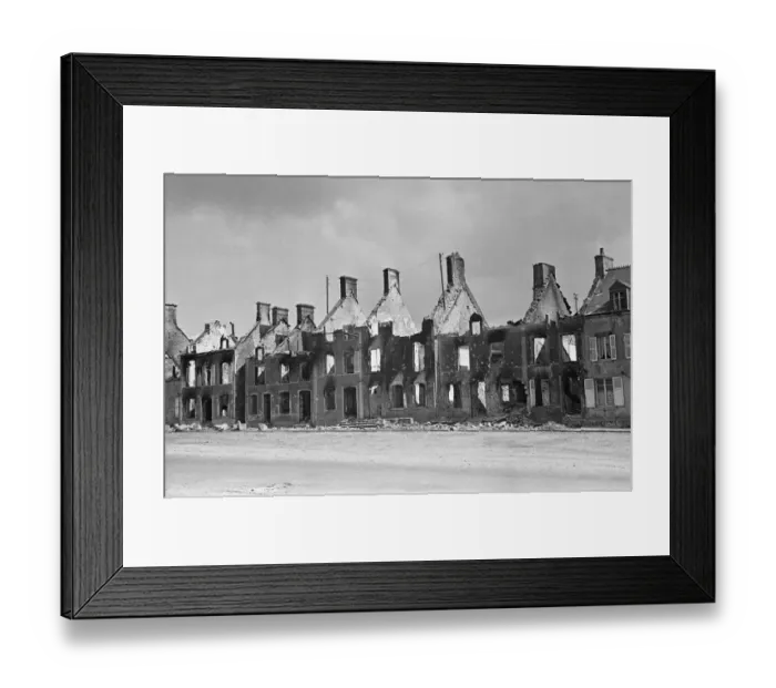 Framed Print : Ruined buildings and wrecked German transport in the streets of Montebourg as a result of