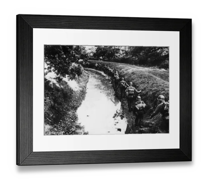 Framed Print : Troops of the 7th Army proceed along a muddy irrigation ditch near Remiremont, France