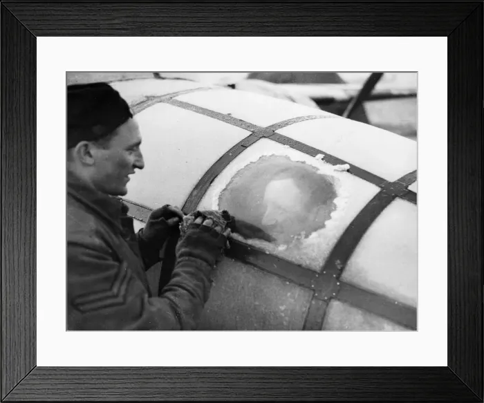 Framed Print : Corporal H Wells of Plumpton, Sussex, wiping ice from the perspex of a Mitchell bomber in Framed Print : Corporal H Wells of Plumpton, Sussex, wiping ice from the perspex of a Mitchell bomber in