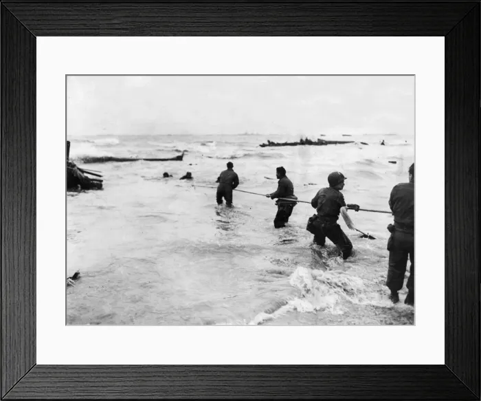 Framed Print : American soldiers waist deep in water, man a lifeline rigged from a swamped landing craft