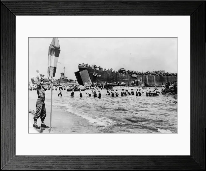 Framed Print : A US Army beach master seen here guiding landing craft to a safe beach area to unload Framed Print : A US Army beach master seen here guiding landing craft to a safe beach area to unload