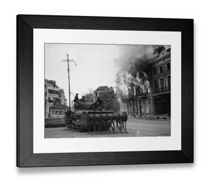 Framed Print : A British Sherman Crab flail tank moves up through the burning buildings in Arnhem Framed Print : A British Sherman Crab flail tank moves up through the burning buildings in Arnhem
