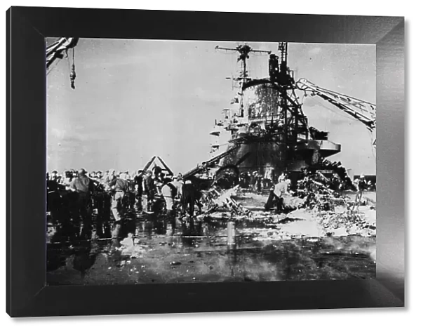 Firefighters on board HMS Formidable inspect the wreckage
