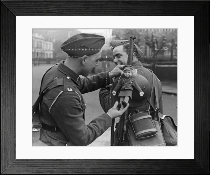 Framed Print : British Army, a fellow soldier adjust the lady doll to his comrades gun Framed Print : British Army, a fellow soldier adjust the lady doll to his comrades gun