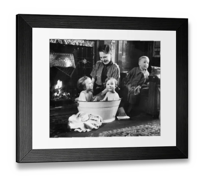 Framed Print : Picture shows a boy scout bathing a baby. Newcastle. Tyne and Wear Framed Print : Picture shows a boy scout bathing a baby. Newcastle. Tyne and Wear