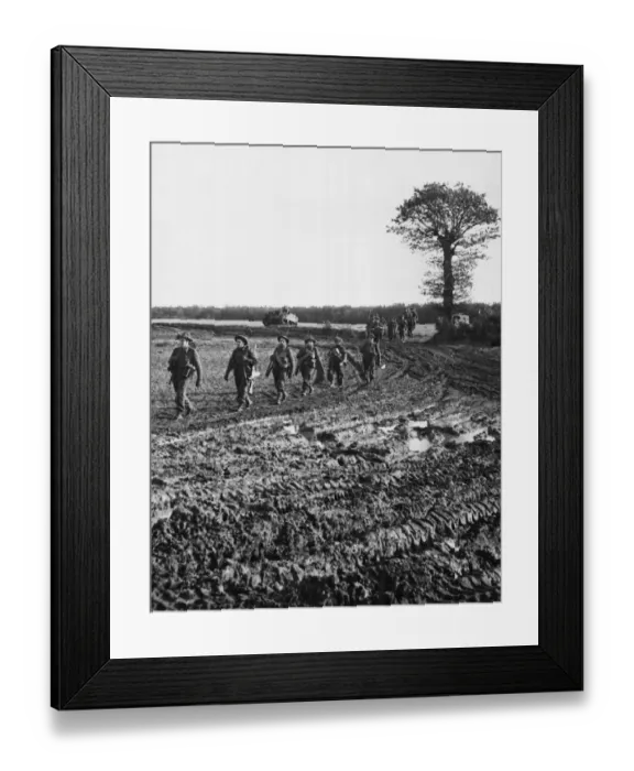 Framed Print : Infantry moving across country and down muddy tracks en route for Geilenkirchen