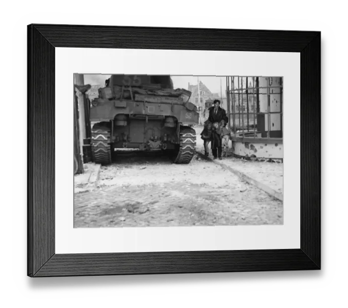 Framed Print : A British Sherman tank pauses for a moment as a Dutch civilian lifts his two children