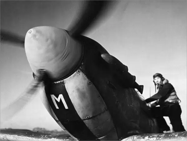 Sergeant S. W. Loader of New Barnet climbs into his Spitfire to join a Channel sweep