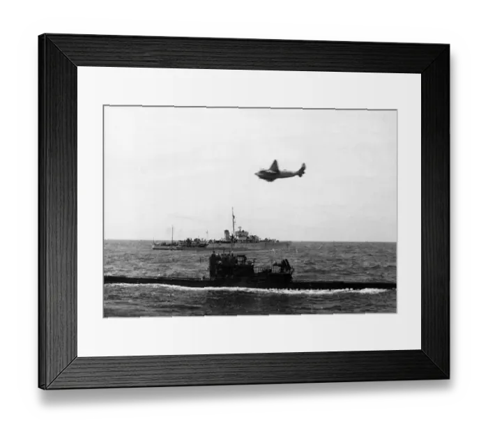 Framed Print : A South African Air Force plane flies over a surrendering U-Boat near Gibraltar. The H. M Framed Print : A South African Air Force plane flies over a surrendering U-Boat near Gibraltar. The H. M