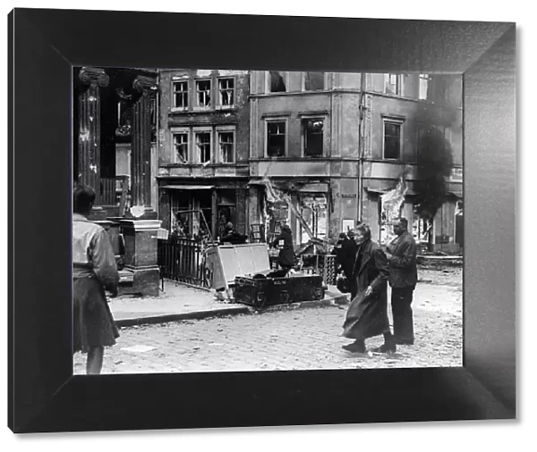 German civilians hurry past a burning building in Bamberg