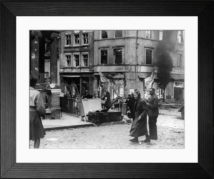 Framed Print : German civilians hurry past a burning building in Bamberg