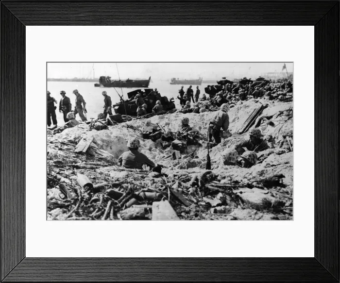 Framed Print : US marines take shelter in a shell hole on Namur Island in the Kwajalein Atoll