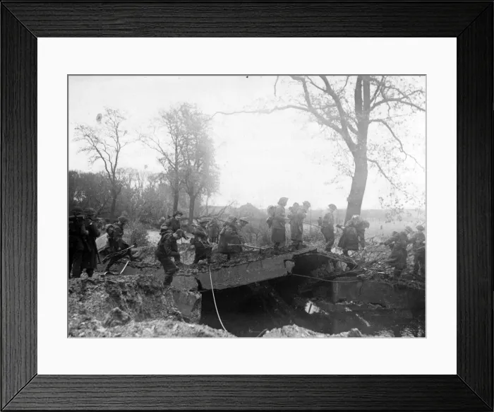 Framed Print : An Allied patrol moves across a damaged bridge over the River Meuse near Broekhuizen Framed Print : An Allied patrol moves across a damaged bridge over the River Meuse near Broekhuizen