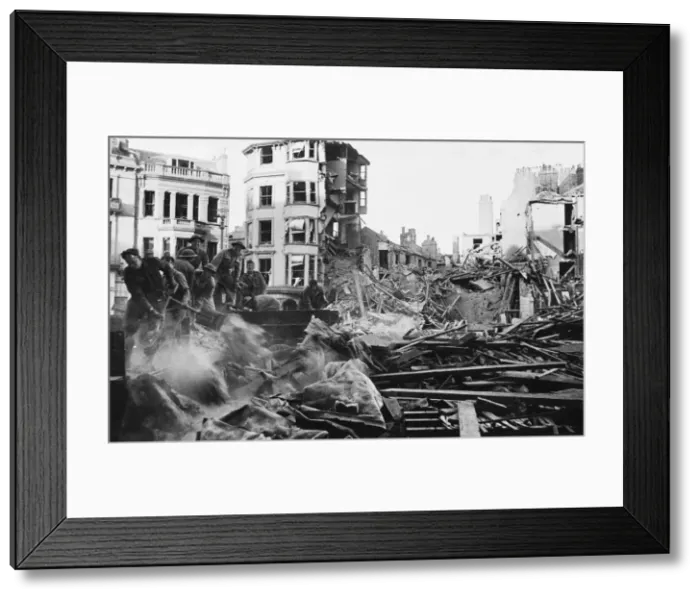 Framed Print : Workers clear rubble after an air raid during Second World War. 28th May 1943 Framed Print : Workers clear rubble after an air raid during Second World War. 28th May 1943