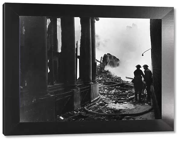 Firemen dampen fires in Paternoster Row following an air raid during Second World War