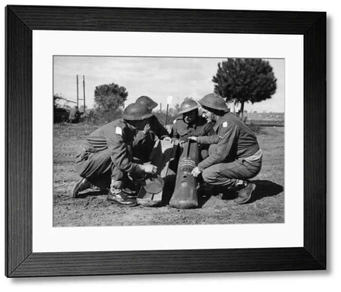 Framed Print : Company Sergeant Major Plunkett explains the working of the butterfly bombs