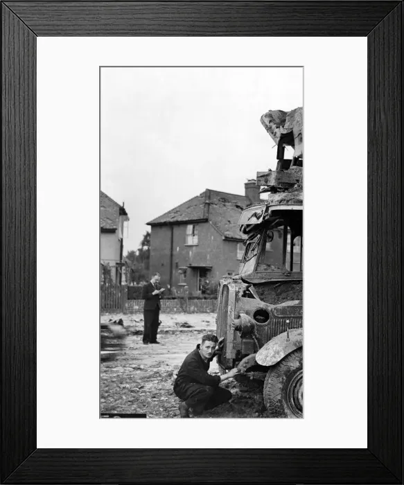 Framed Print : Air Raid damage during the Second World War, a man looking at damage to a bus