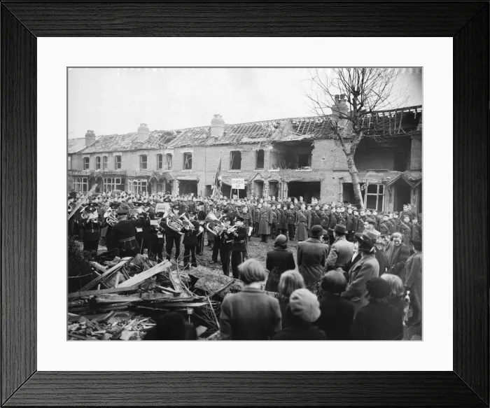 Framed Print : A military band perform some music infant of a row of houses that have been destroyed in Framed Print : A military band perform some music infant of a row of houses that have been destroyed in