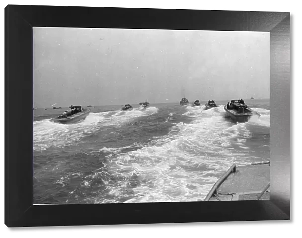 The Landing Craft Personnel or LCP speed towards their rendezvous