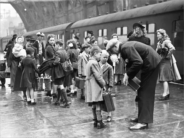 London evacuees return from Suffolk. Parents greeting their children on arrival at St