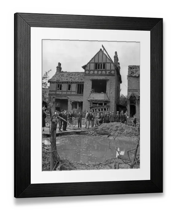Framed Print : Residents gather around a water filled crater outside a house in Wood End Road, Erdington Framed Print : Residents gather around a water filled crater outside a house in Wood End Road, Erdington