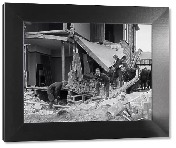 A demolition squad make safe a bomb damaged building at Hodge Hill Common following a