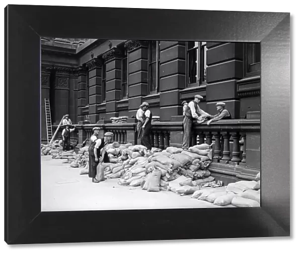 Sandbags being placed against the walls of the Birmingham Education Committee building in
