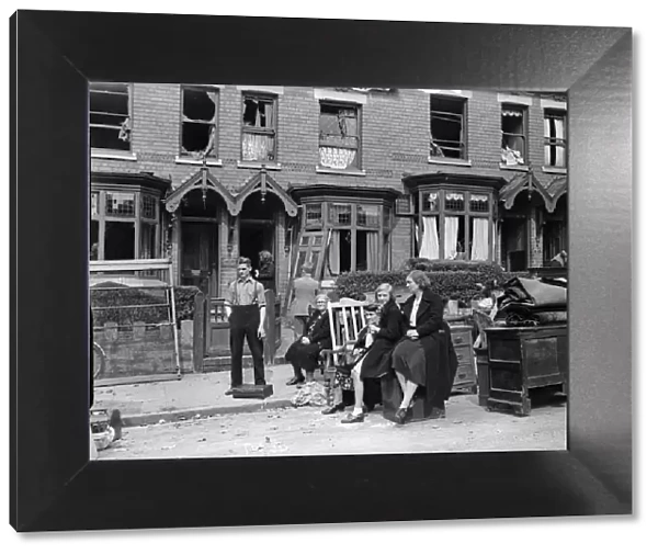 Householders removing furniture from their bomb damage home in Smallheath