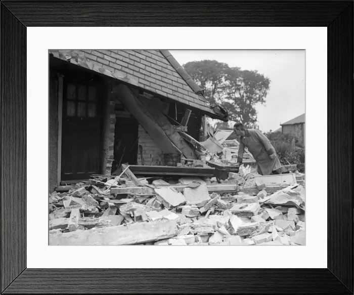 Framed Print : Milkman examines the staircase of a damage house in Tyburn Road, Edrdington Framed Print : Milkman examines the staircase of a damage house in Tyburn Road, Edrdington